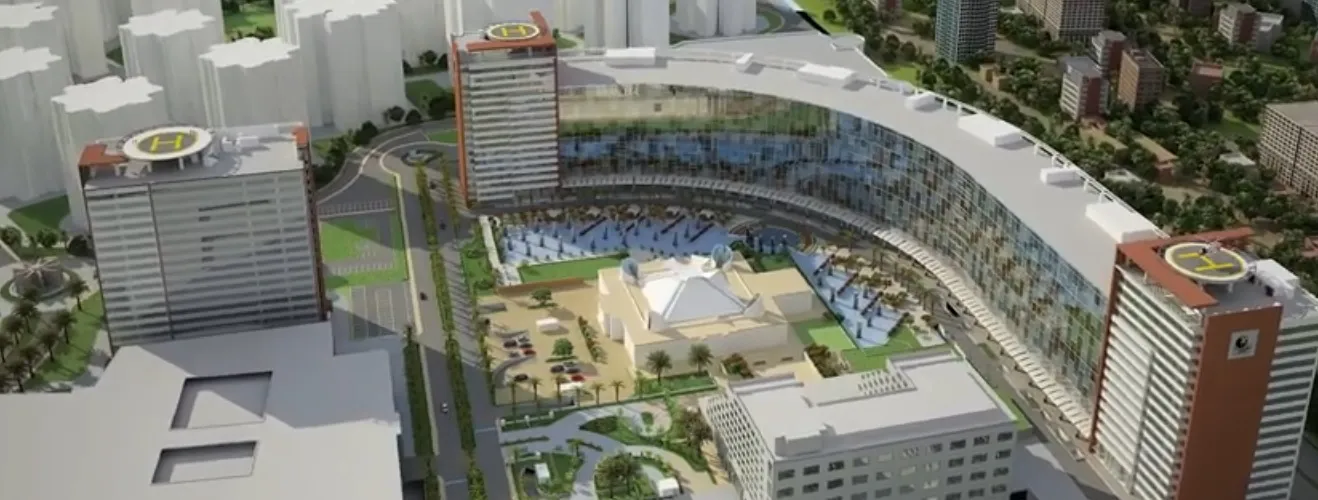 Prestige Shantiniketan Whitefield Bangalore An architectural model rendering of the Prestige Shantiniketan integrated township located in Whitefield, Bangalore. The large-scale development comprises residential towers, commercial office spaces, a shopping mall, a hotel, a convention center, and landscaped green spaces spread across 105 acres. The central feature is a curved glass-facade commercial building with an adjoining outdoor plaza area surrounded by high-rise towers for residences, offices, and hospitality services, creating a self-contained township environment.