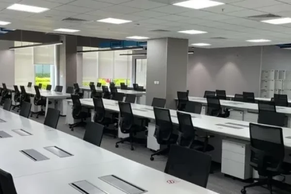 Commercial building in Lavelle Road Bangaloreoffices Prestige Lavelle road coworking office space with rows of desks, ergonomic chairs, and computer workstations. The area features modern design elements, ample lighting, and a professional environment suitable for individuals or teams seeking flexible and tech-enabled workspace solutions.